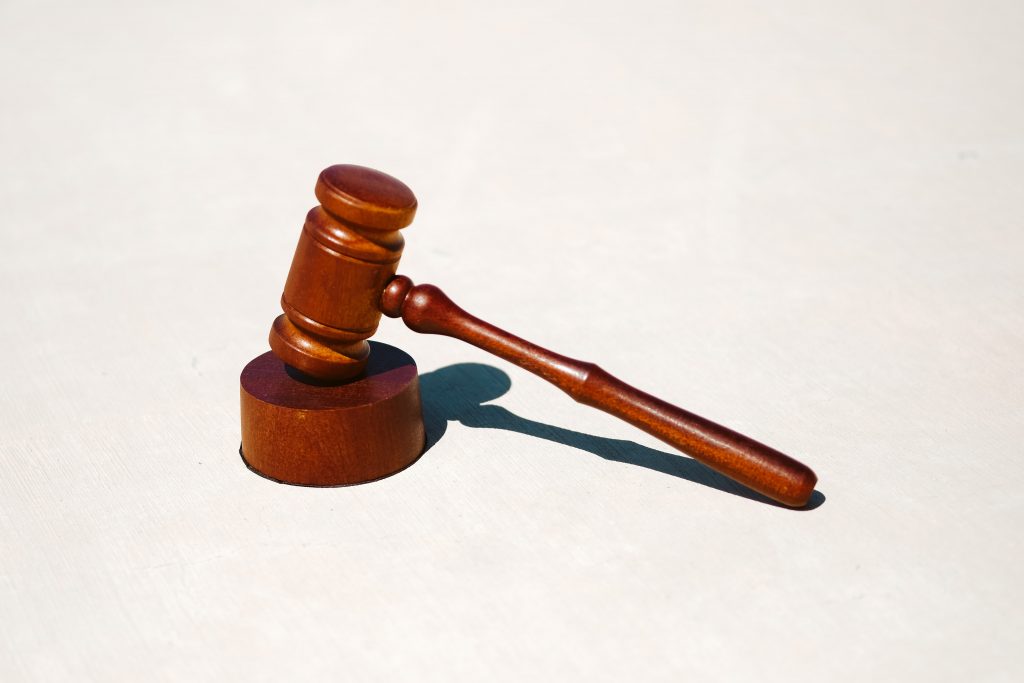 A wooden gavel on a white surface